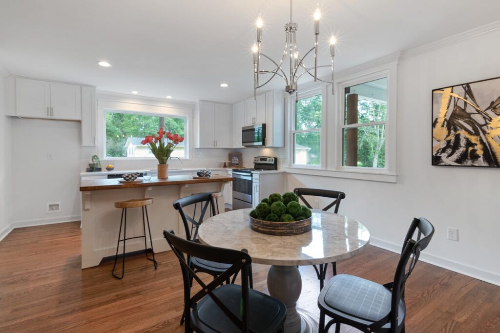 Bright modern kitchen and dining space with elegant decor and natural light.